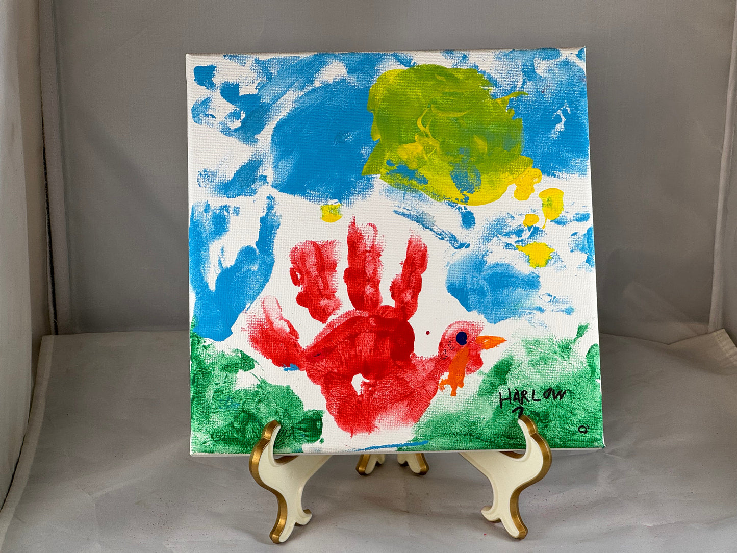 Kid art for sale to help those in need. Pictured "Hand Turkey" by Harlow, Cub Scout Pack 684 (Canvas, 8" x 8")