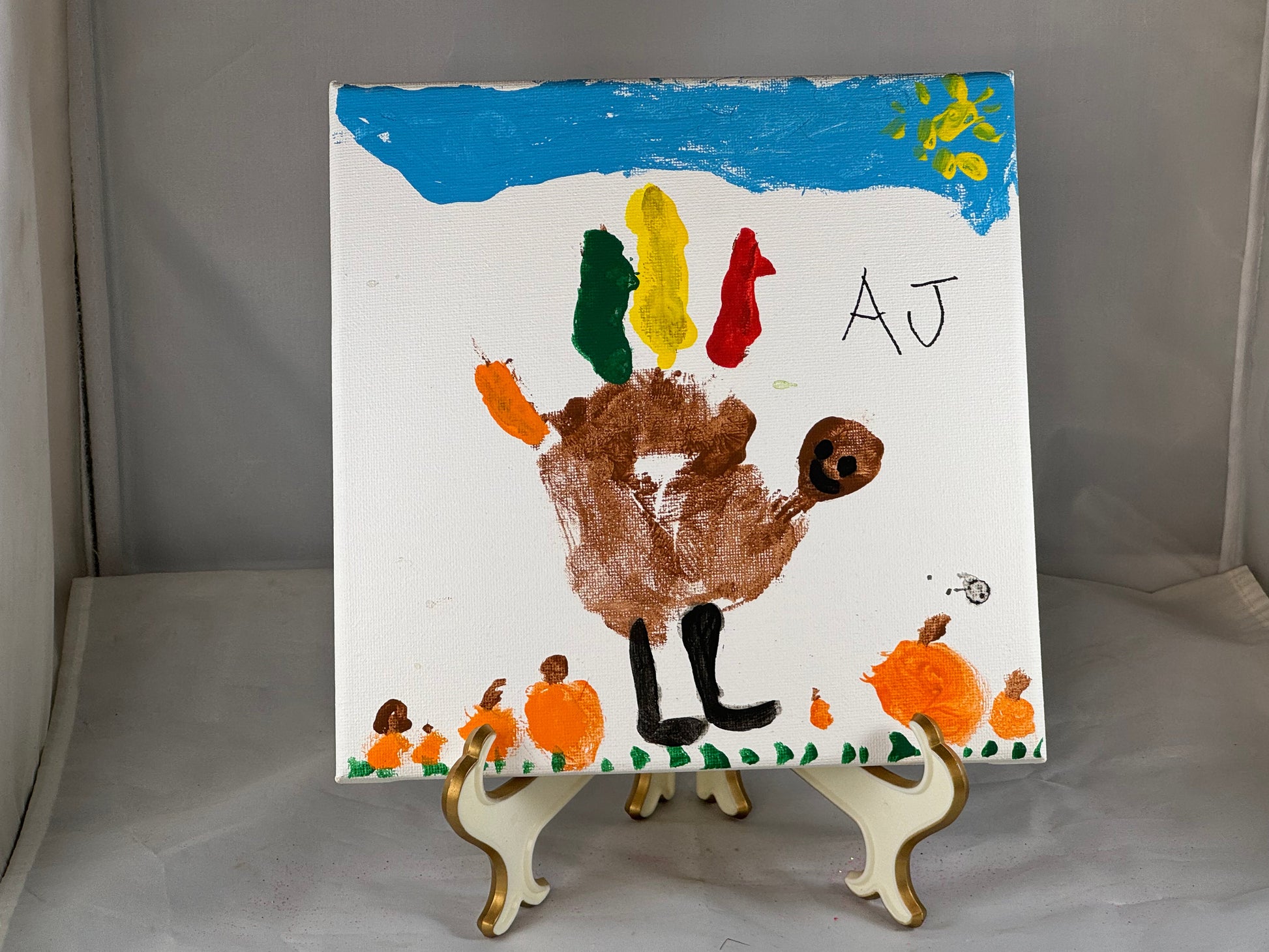 Kid art for sale to help those in need. Pictured "Hand Turkey" by AJ, Cub Scout Pack 684 (Canvas, 8" x 8")