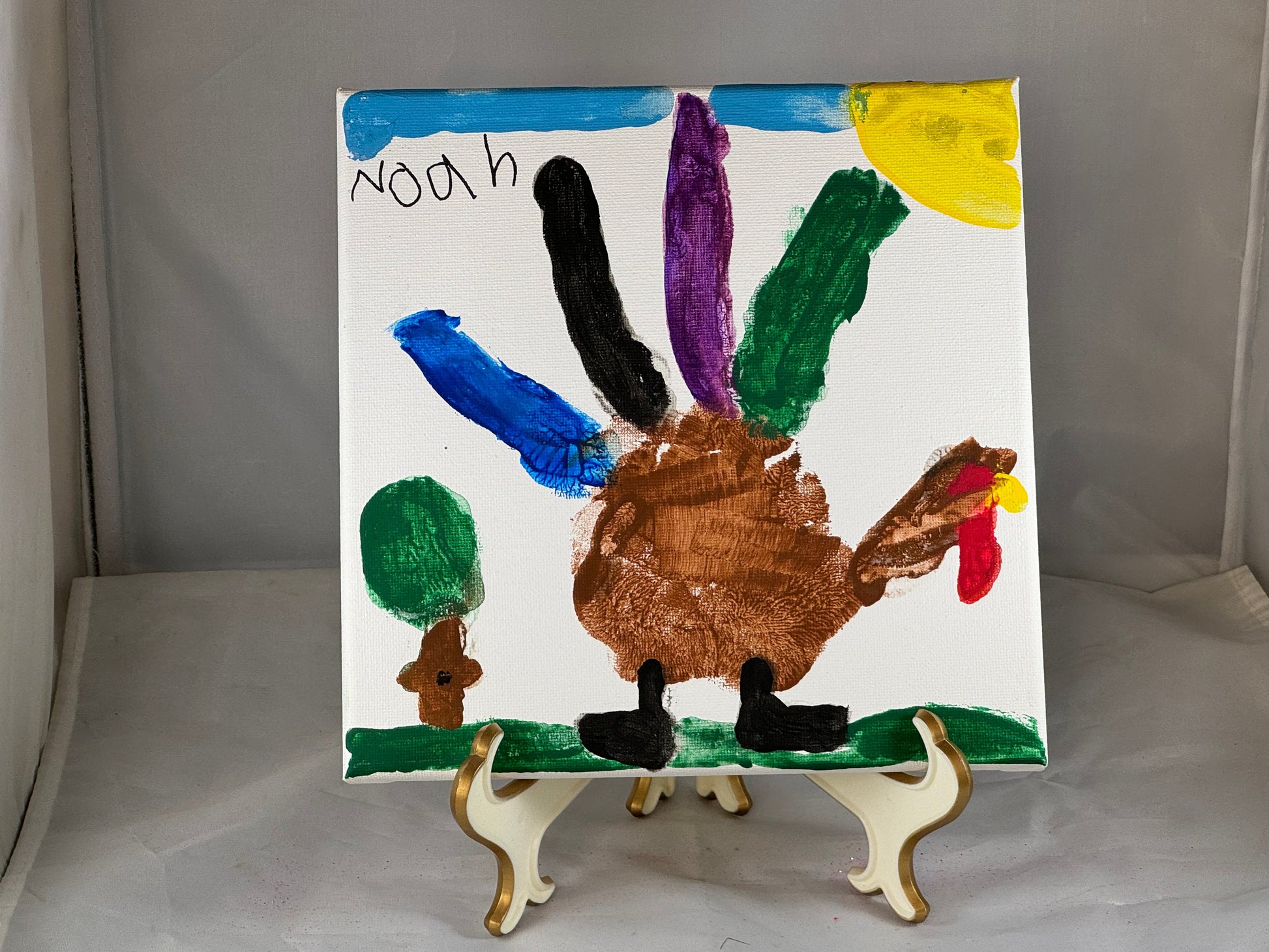 Kid art for sale to help those in need. Pictured "Hand Turkey" by Noah, Cub Scout Pack 684 (Canvas, 8" x 8")